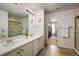 Elegant bathroom with double sinks, walk-in shower, and a large closet at 21837 E Stanford Cir, Aurora, CO 80015