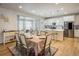 Kitchen and dining area with white cabinets, island, and hardwood floors at 21837 E Stanford Cir, Aurora, CO 80015