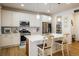 Modern kitchen with white cabinets, stainless steel appliances, and island at 21837 E Stanford Cir, Aurora, CO 80015
