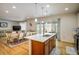 Open concept kitchen and dining area with island and hardwood floors at 21837 E Stanford Cir, Aurora, CO 80015