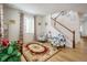 Bright living room with hardwood floors, comfortable seating, and a staircase at 21837 E Stanford Cir, Aurora, CO 80015