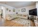 Spacious living room with large sectional sofa and flat-screen TV at 21837 E Stanford Cir, Aurora, CO 80015