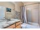Bathroom featuring a single sink vanity with a granite countertop, a tub, and a tiled shower at 22560 E Ontario Dr # 204, Aurora, CO 80016