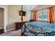 Bedroom with a four-poster bed, dresser, TV, window, and an abstract patterned comforter at 22560 E Ontario Dr # 204, Aurora, CO 80016