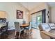 Cozy dining area with a round table, chandelier, and sliding glass door leading to the balcony at 22560 E Ontario Dr # 204, Aurora, CO 80016