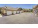Row of multiple garages featuring white doors, stone accents and a spacious parking area at 22560 E Ontario Dr # 204, Aurora, CO 80016