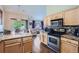 Bright kitchen with modern appliances, hardwood floors and an island with beautiful granite countertops at 22560 E Ontario Dr # 204, Aurora, CO 80016