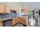 Bright kitchen featuring wooden cabinets, stainless steel appliances, and granite countertops by the dining area at 22560 E Ontario Dr # 204, Aurora, CO 80016