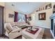 Comfortable living room with a plush couch, area rug, and bright natural light from a large window at 22560 E Ontario Dr # 204, Aurora, CO 80016