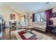 Cozy living room featuring hardwood floors, a comfortable couch, and a dining area with natural light at 22560 E Ontario Dr # 204, Aurora, CO 80016