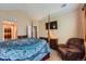 Spacious bedroom with four-poster bed, TV, dresser, sitting chair, and multiple closets at 22560 E Ontario Dr # 204, Aurora, CO 80016