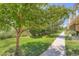 Landscaped yard with mature trees and a stone walkway that leads to the building at 22560 E Ontario Dr # 204, Aurora, CO 80016