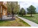 A paved pathway meanders alongside a home with a fenced patio in the backyard at 3760 Ute Mountain Trl, Castle Rock, CO 80109