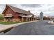 Community building with stone accents and a metal roof next to a paved parking area at 3760 Ute Mountain Trl, Castle Rock, CO 80109