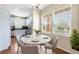 Charming dining area with a round table, hardwood floors, and large windows at 3760 Ute Mountain Trl, Castle Rock, CO 80109