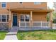 Inviting front porch with stone accents, covered entry, and well-maintained landscaping at 3760 Ute Mountain Trl, Castle Rock, CO 80109