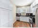 Contemporary kitchen featuring stainless steel appliances, white cabinets, and hardwood floors at 3760 Ute Mountain Trl, Castle Rock, CO 80109