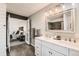 Modern bathroom with double vanity, neutral walls, and a view into the bedroom at 5155 E 108Th Pl, Thornton, CO 80233