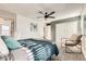 Bright, carpeted bedroom with natural light, featuring ceiling fan and neutral decor at 5155 E 108Th Pl, Thornton, CO 80233
