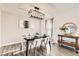 Modern dining room with a statement chandelier, hardwood floors, and contemporary decor at 5155 E 108Th Pl, Thornton, CO 80233