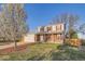 Charming two-story home featuring red shutters, brick accents, a well-maintained lawn, and mature trees at 5155 E 108Th Pl, Thornton, CO 80233