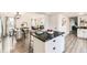 Beautiful kitchen with a center island, stainless appliances, and an open view into the dining and living areas at 5155 E 108Th Pl, Thornton, CO 80233