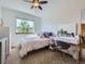 Inviting bedroom with a white bed, natural light, a view, and a stylish vanity at 6366 Umber Cir, Arvada, CO 80403