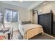 Cozy bedroom features a comfortable bed, stylish dresser, and a bright window at 6366 Umber Cir, Arvada, CO 80403