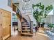 Grand foyer featuring a curved staircase, hardwood floors, and an open view to the dining room at 6366 Umber Cir, Arvada, CO 80403