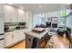Spacious kitchen with an island, modern cabinetry, and a seamless transition to the living room with fireplace at 6366 Umber Cir, Arvada, CO 80403