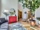 Well-lit living room showcasing a decorative mirror and an open view to the foyer and staircase at 6366 Umber Cir, Arvada, CO 80403