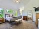 Spacious main bedroom with a comfortable bed, neutral colors, and large window overlooking nature at 6366 Umber Cir, Arvada, CO 80403