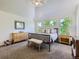 Bright main bedroom filled with natural light, offering a large bed, a neutral color scheme and beautiful views at 6366 Umber Cir, Arvada, CO 80403