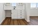 Functional bar area features white cabinets, black hardware, and a sink, ideal for entertaining guests at 4949 Hickory Oaks St, Castle Rock, CO 80104