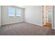 An empty bedroom featuring neutral carpet, natural light from large windows, and white trim at 4949 Hickory Oaks St, Castle Rock, CO 80104