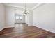 Elegant dining room with wood floors, a modern chandelier, and large windows, perfect for entertaining at 4949 Hickory Oaks St, Castle Rock, CO 80104