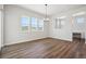 Bright dining room featuring wood floors, modern chandelier, and large windows offering scenic views at 4949 Hickory Oaks St, Castle Rock, CO 80104