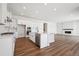 Open kitchen with white cabinets, stainless steel appliances, a large island, and view into the living room at 4949 Hickory Oaks St, Castle Rock, CO 80104