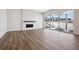 A spacious living room featuring a modern fireplace, wood floors, and a sliding glass door at 4949 Hickory Oaks St, Castle Rock, CO 80104