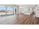 Open-concept living space with wood flooring, a modern kitchen, and large sliding glass doors at 4949 Hickory Oaks St, Castle Rock, CO 80104