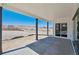 Covered patio with dark columns overlooking a picturesque landscape at 4949 Hickory Oaks St, Castle Rock, CO 80104