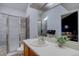 Bathroom featuring glass shower, updated vanity, and view to bedroom at 3030 W Prentice Ave # G, Littleton, CO 80123