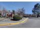 Wide angle shot of Steeplechase II community sign with a paved sidewalk bordering the curb at 3030 W Prentice Ave # G, Littleton, CO 80123