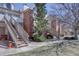 Townhome exterior with brick accents, exterior staircase, and well-maintained landscaping at 3030 W Prentice Ave # G, Littleton, CO 80123