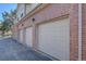 Row of garages showcasing brick exterior, and well-maintained doors at 3030 W Prentice Ave # G, Littleton, CO 80123