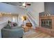 Bright living room with vaulted ceilings, fireplace, wood floors and open staircase at 3030 W Prentice Ave # G, Littleton, CO 80123