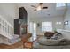 Spacious living area featuring a fireplace, staircase, and cozy seating arrangement at 3030 W Prentice Ave # G, Littleton, CO 80123