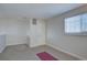 Room with neutral carpeting, window with blinds, and simple lighting at 3030 W Prentice Ave # G, Littleton, CO 80123