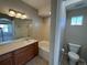 Bathroom featuring a tub, vanity with sink, and large mirror; natural light enters through a small window at 13013 Grant Cir # C, Thornton, CO 80241