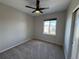 Cozy bedroom with plush carpet, a ceiling fan, and a bright window at 13013 Grant Cir # C, Thornton, CO 80241